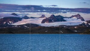Photographie de paysage avec un lac positionné sur la ligne de tiers inférieure, créant un équilibre visuel entre eau, montagne et ciel.