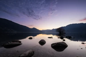 Bracketing sur un lac au crépuscule pour conserver les détails dans le ciel et le premier plan.