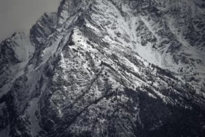 Parois de montagne striées de neige, textures minérales en hiver