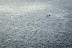 Bateau isolé en mer dans une composition épurée, sans éléments perturbateurs, pour une image plus lisible